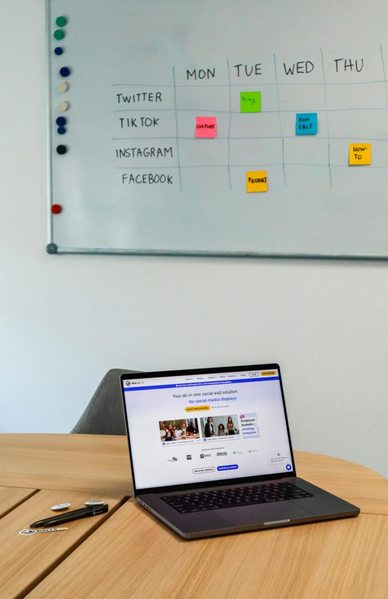 Laptop on Table in Conference Room with Whiteboard